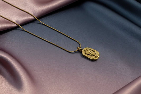 18k gold plated rose pendant necklace elegantly displayed on silky fabric