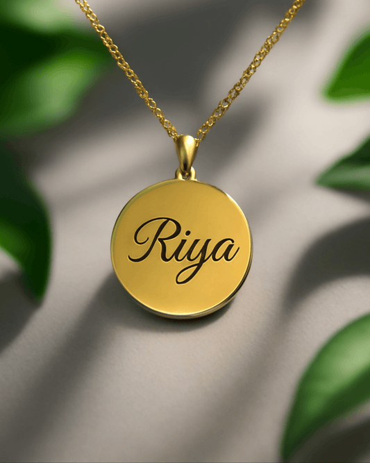 Custom round pendant in gold with personalized engraving of the name Riya, elegant and stylish necklace