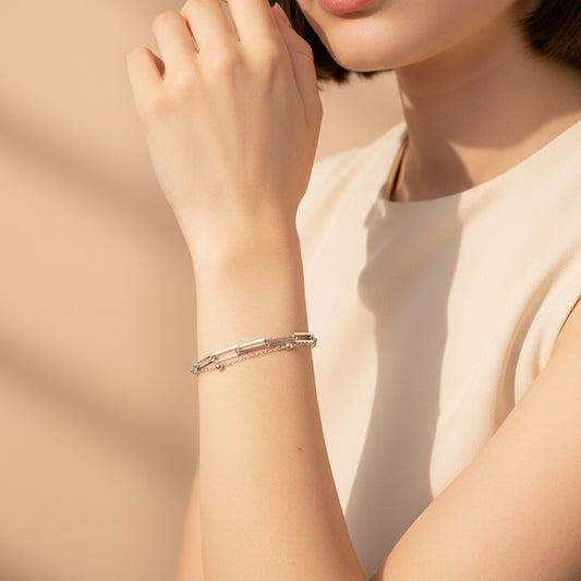 Elegant model wearing a dual layer silver paperclip chain bracelet, showcasing its modern design