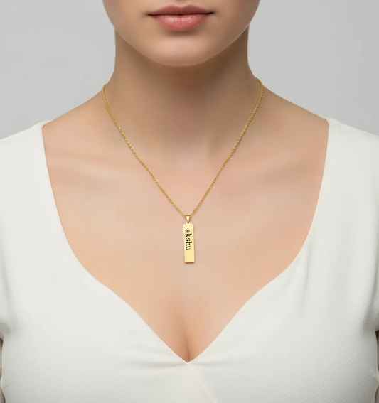 Customizable gold bar pendant necklace with engraved name akshu on a gold chain