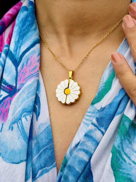 Custom daisy pendant necklace with gold chain worn with a blue floral scarf