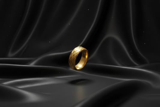 Gold stainless steel ring for men with a textured surface, placed on black satin fabric
