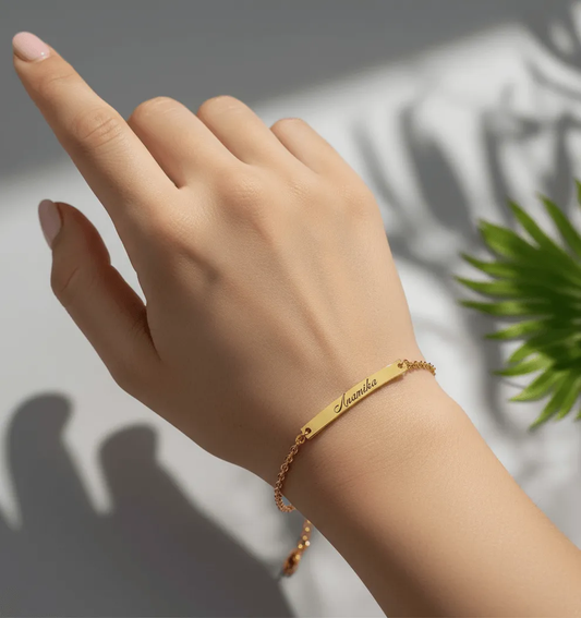 Lustre of Love personalized gold bar bracelet with delicate chain and name engraving on a white surface