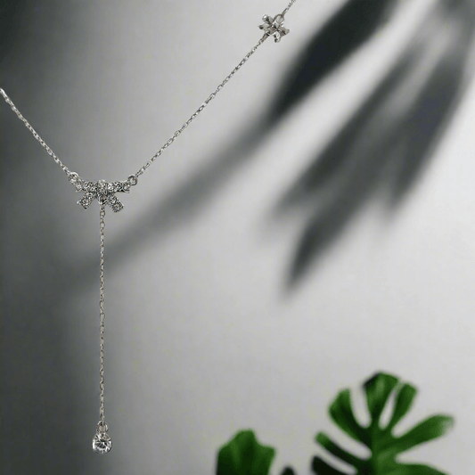 Lustre of Love delicate silver necklace featuring a sparkling bow charm with a dangling crystal drop