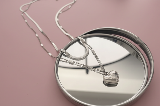 Lustre of Love silver layered heart necklace displayed on a reflective surface