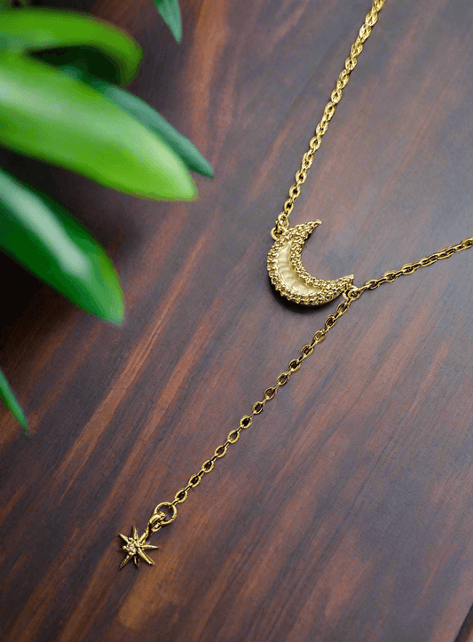 Lustre of Love gold crescent moon and star pendant necklace on wooden surface