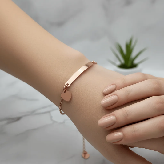 Lustre of Love delicate rose gold bracelet with a heart charm on a marble surface