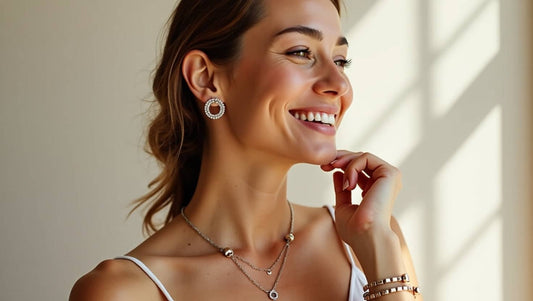 Smiling woman wearing elegant waterproof jewellery including earrings, necklace, and bracelets in natural light