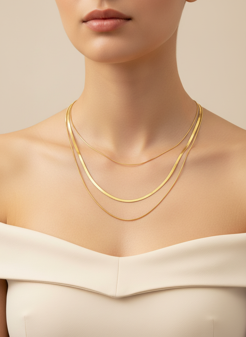 Elegant 18k gold plated layered snake chain necklace worn by a model with a stylish top