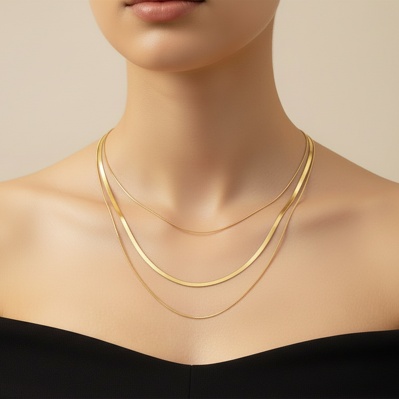 Elegant 18k gold plated layered snake chain necklace displayed on a model's neckline