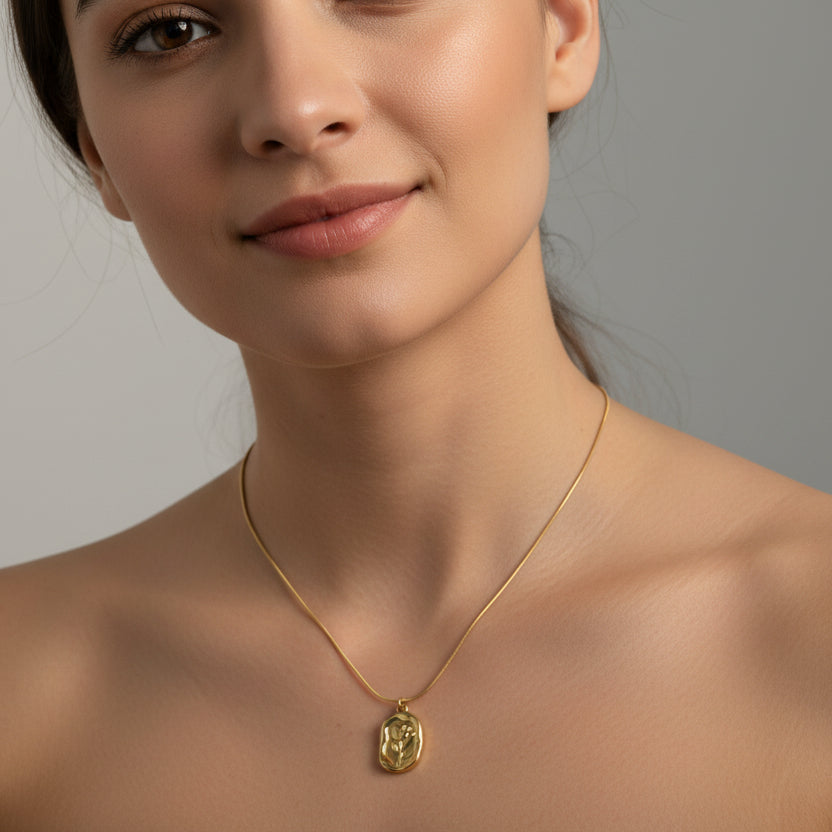 Elegant model wearing an 18k gold plated rose pendant necklace against a neutral background