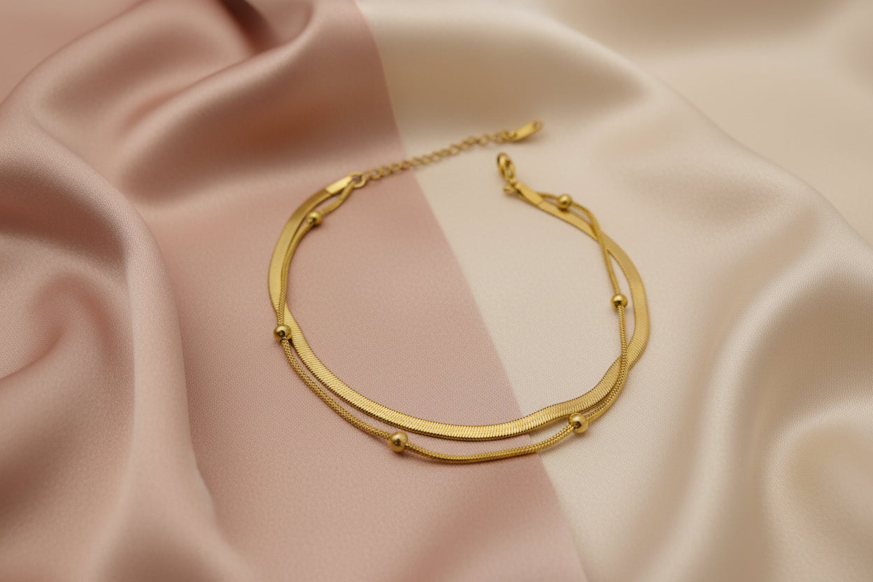 Elegant 18k gold plated snake chain bracelet with smooth curves and decorative beads