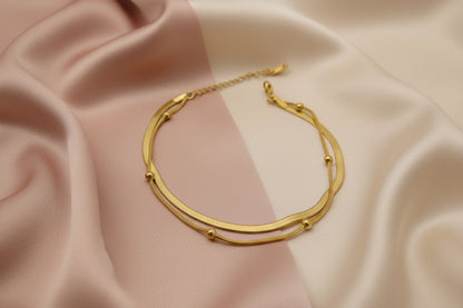 Elegant 18k gold plated snake chain bracelet with smooth curves and decorative beads
