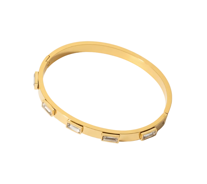 Gold bracelet with embedded stones on a white background