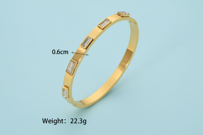 Lustre of Love 18k gold plated stainless steel bangle with elegant design and gemstones
