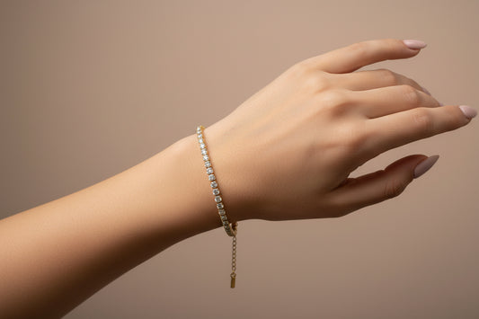 Elegant hand wearing an 18k gold plated tennis bracelet with sparkling stones for a luxurious look