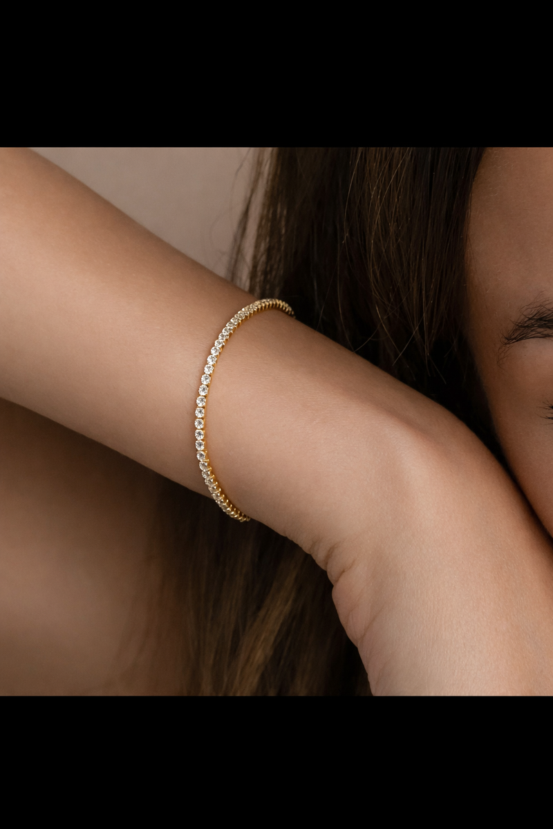 18k gold plated tennis bracelet on a woman's wrist for a touch of elegance and luxury
