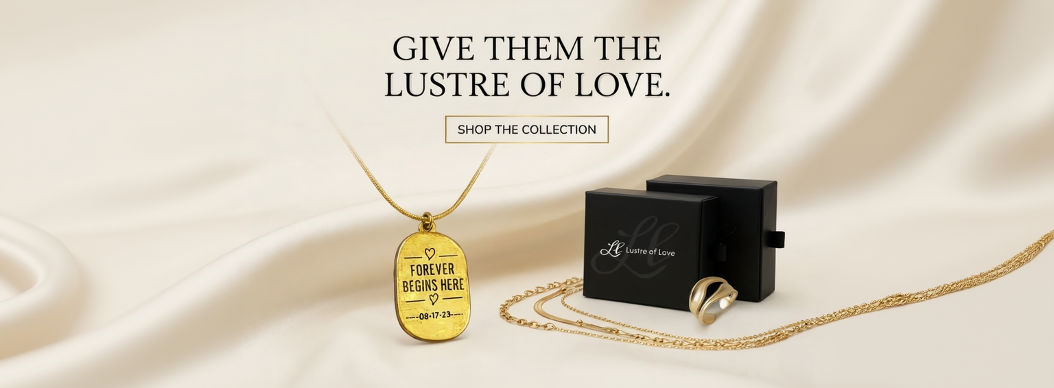 Jewelry set with gold pendant and black box on a beige fabric background, featuring text 'Give them the lustre of love.'