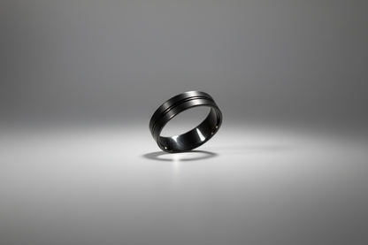 Black stainless steel ring with a sleek, modern design featuring two horizontal grooves