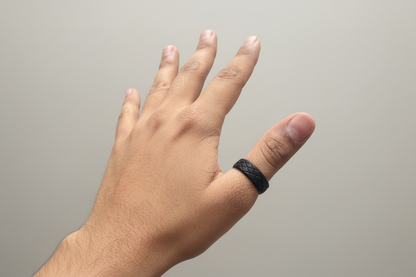 Lustre of Love black stainless steel ring worn on a hand with a textured finish