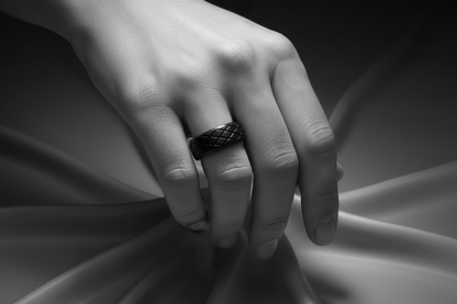 Elegant black stainless steel ring displayed on a hand with a textured design for sophisticated style