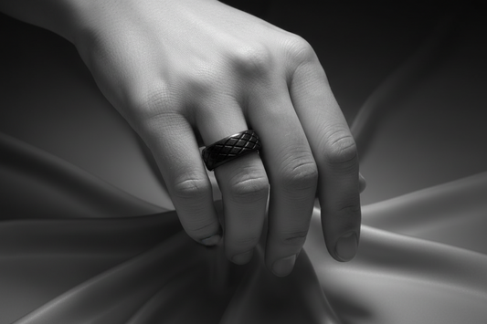Elegant black stainless steel ring displayed on a hand with a textured design for sophisticated style