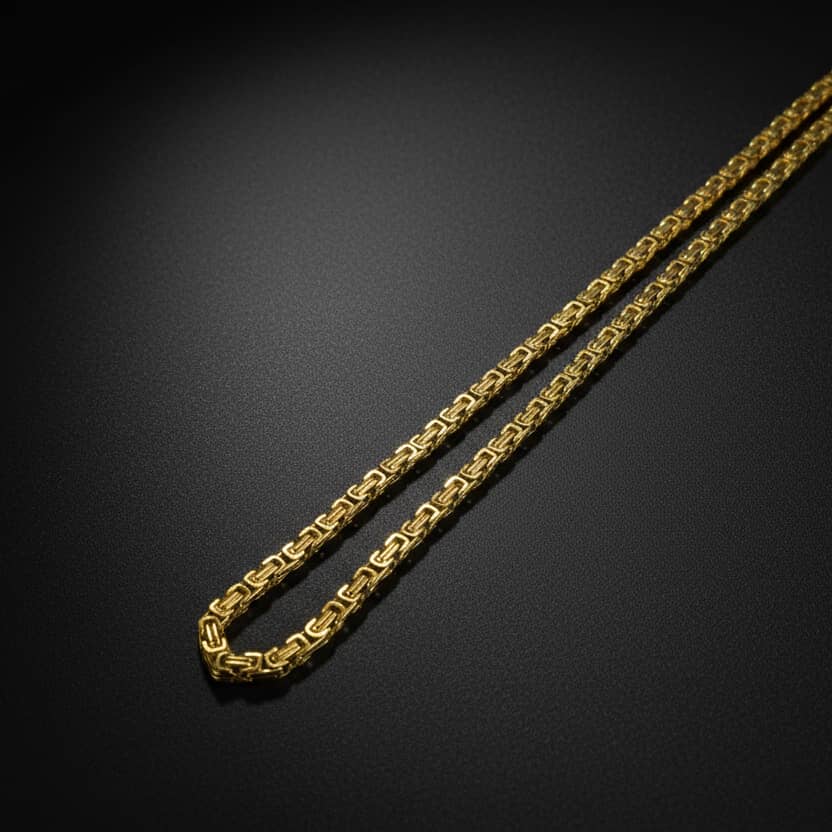 Lustre of Love Byzantine Gold Chain, intricately designed and shining luxuriously on a black background