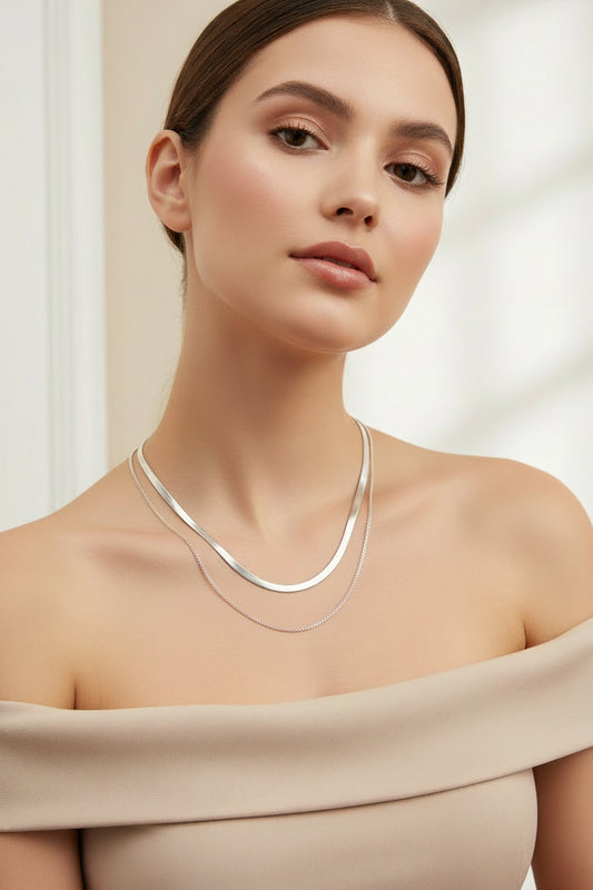Model wearing a dual layer silver chain necklace that adds elegance to any outfit