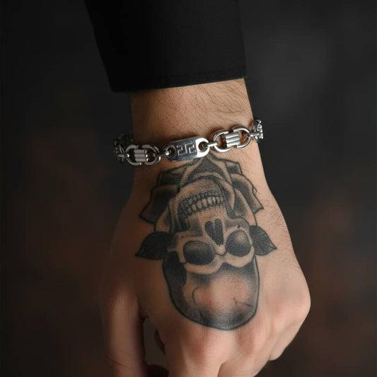 Stylish Givenchy bracelet on a tattooed hand, featuring skull and floral designs