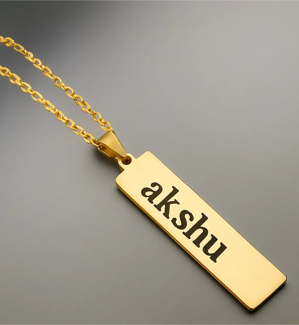 Customizable gold bar pendant necklace with engraved name akshu on a gold chain