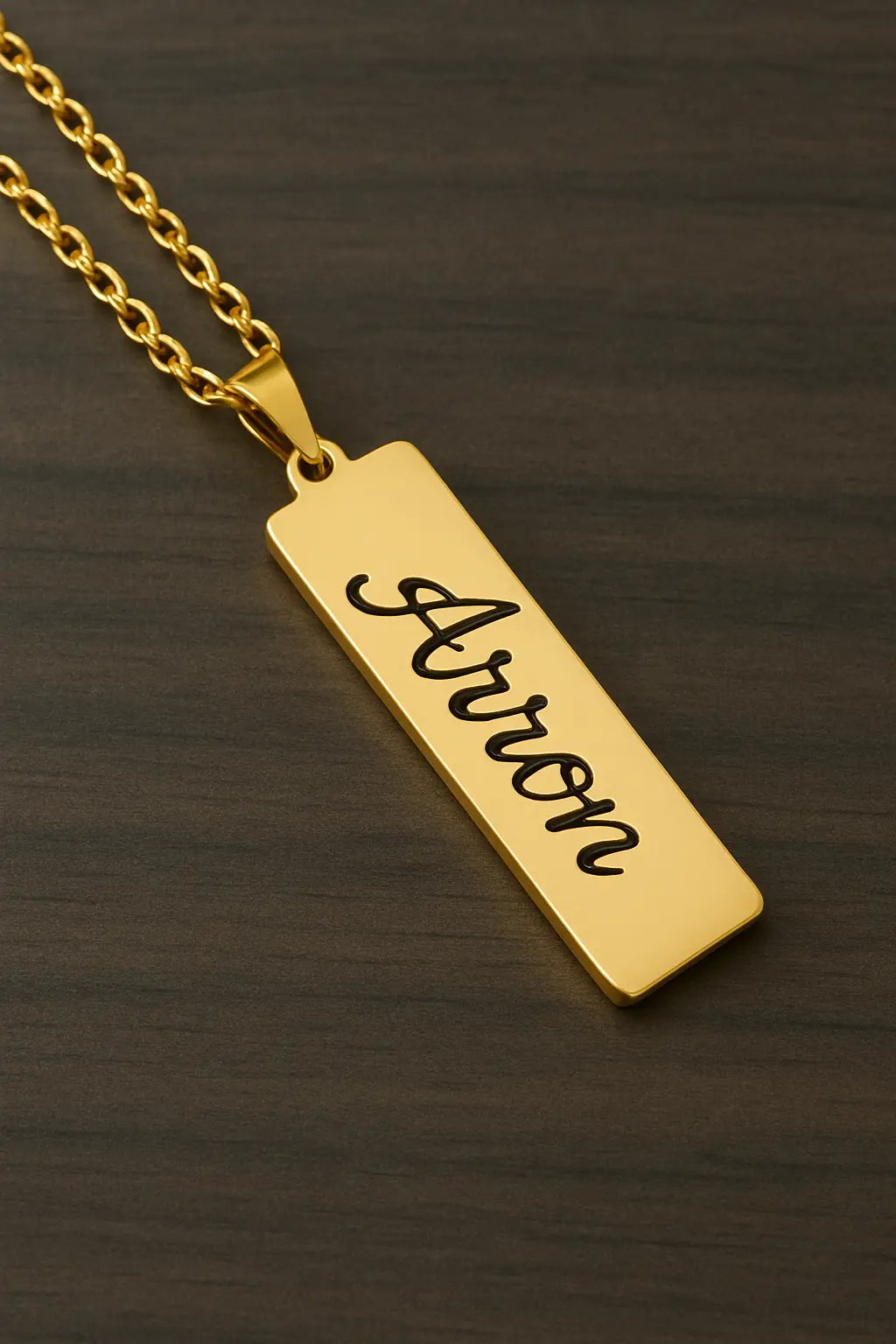Gold bar pendant with custom name engraving Aaron on a gold chain necklace