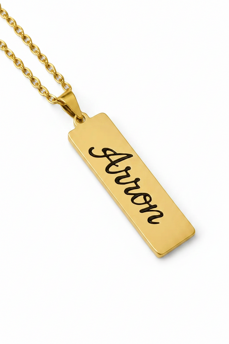 Gold bar pendant with custom name engraving Aaron on a gold chain necklace