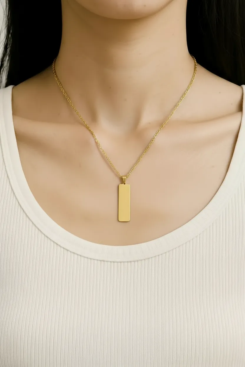 Lustre of Love gold bar pendant necklace worn on a white ribbed tank top