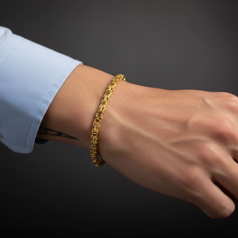 Gold Byzantine Link Chain Bracelet elegantly displayed on a wrist with a stylish shirt