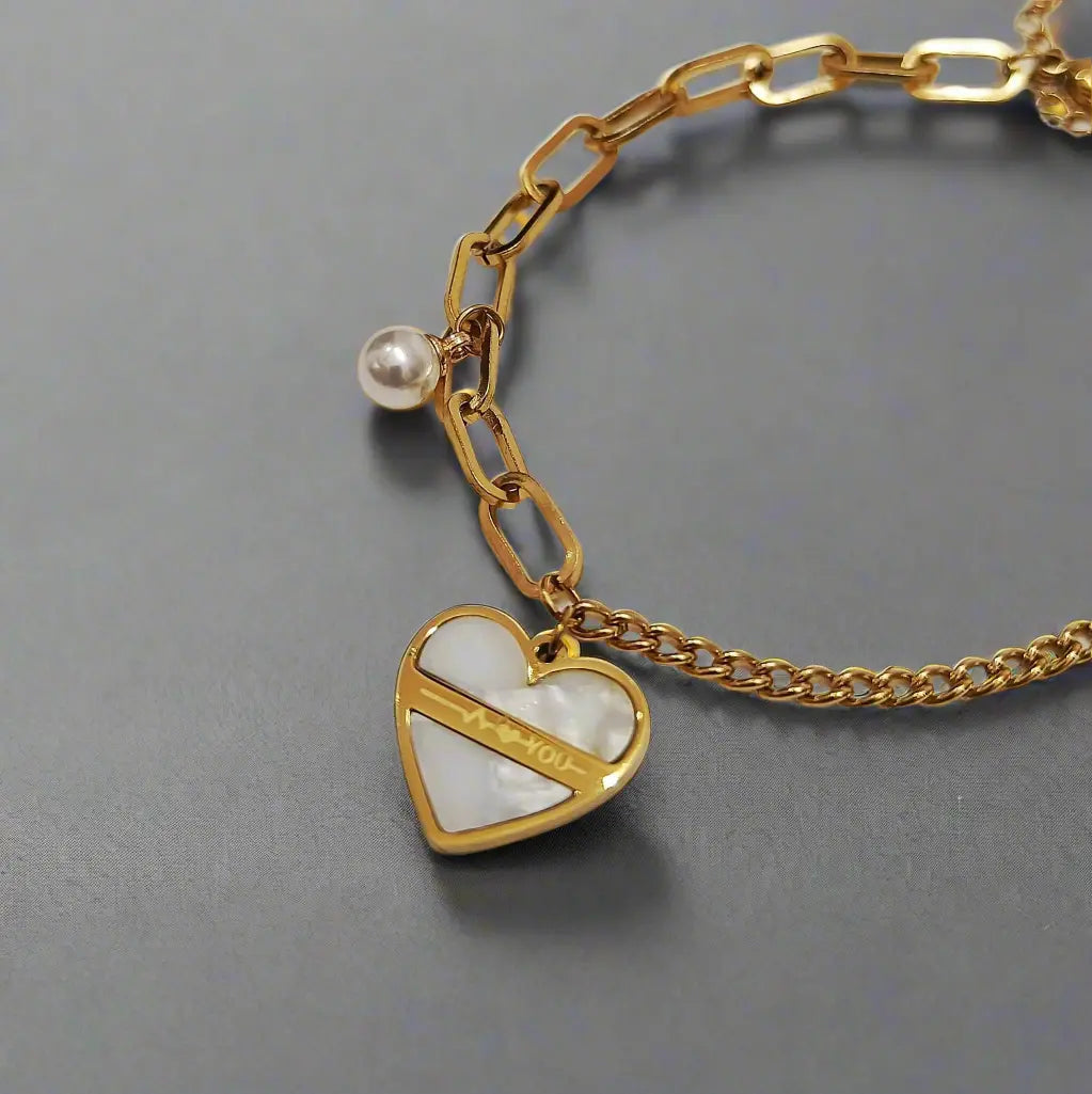 Lustre of Love gold chain heart charm bracelet with pearl detail and white enamel heart pendant