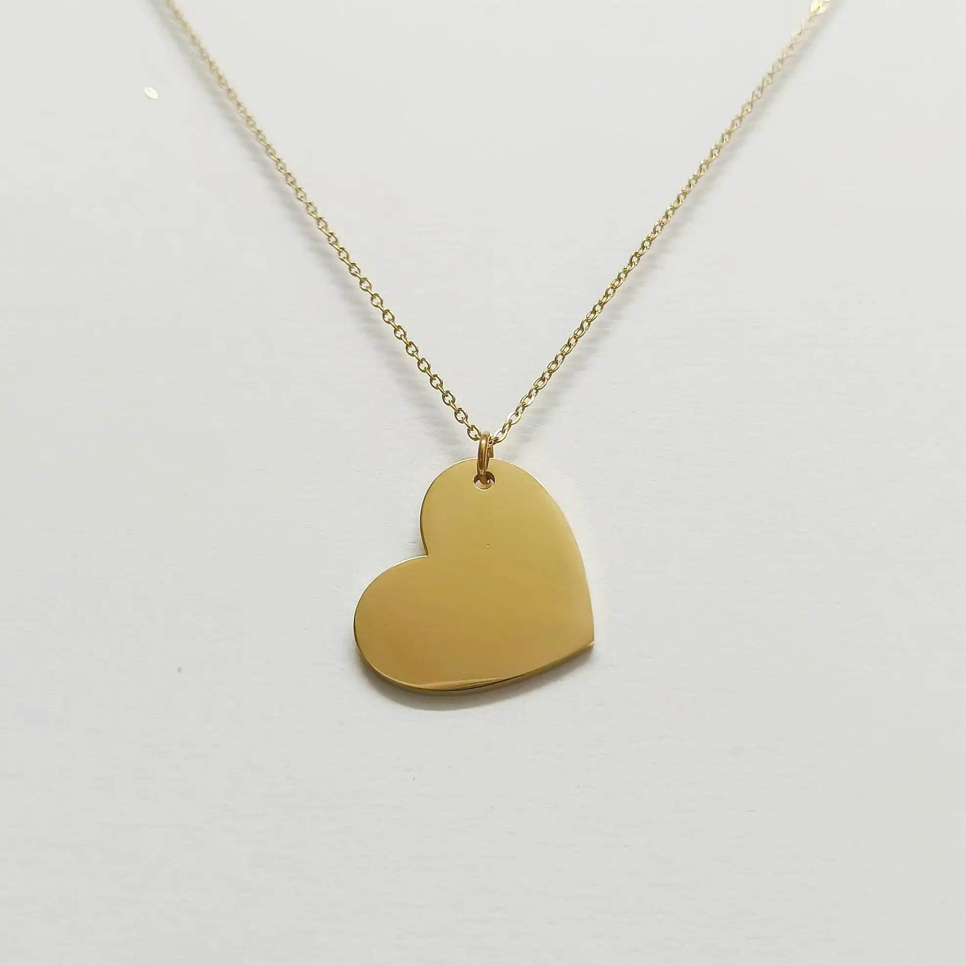 Lustre of Love gold heart pendant necklace with smooth polished surface on delicate chain