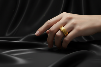 Stylish gold stainless steel ring for men showcased on a hand against dark silky fabric