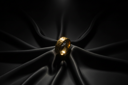 Stylish gold stainless steel ring for men with a textured design on a dark satin background