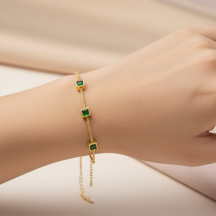 Elegant green zircon bracelet gold plated featuring three sparkling stones on a delicate chain