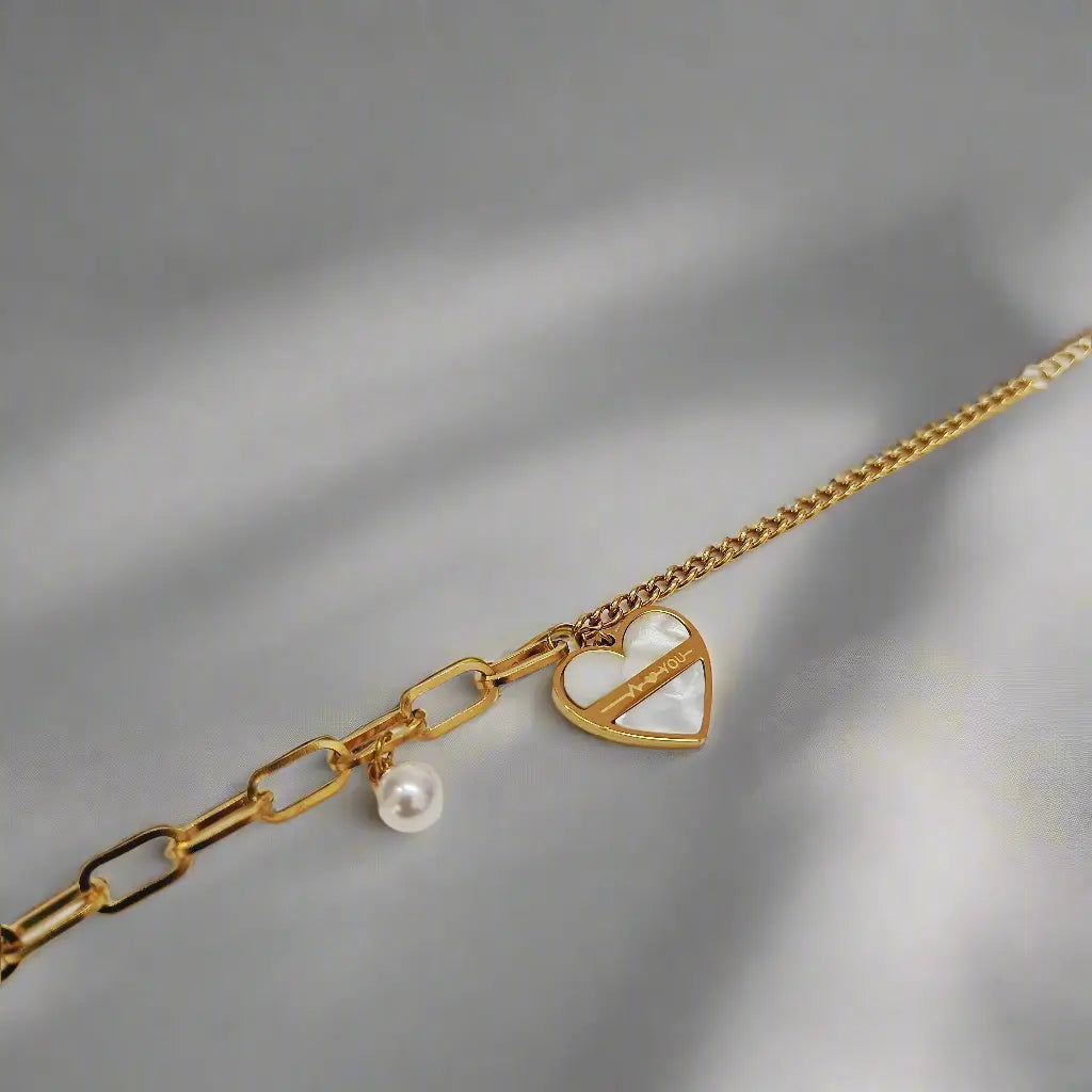 Lustre of Love gold heart charm bracelet with pearl detail on a delicate chain