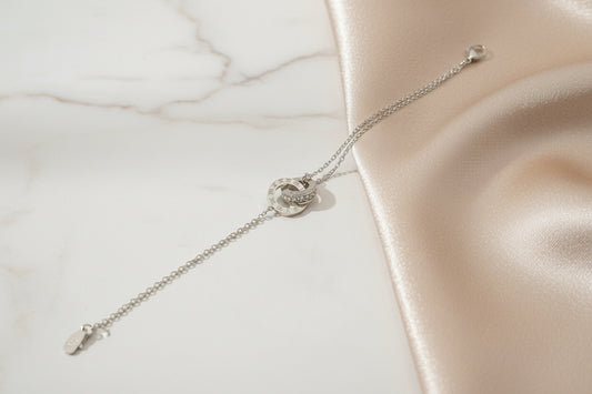 Lustre of Love interlocking circles bracelet stainless steel on a soft satin background