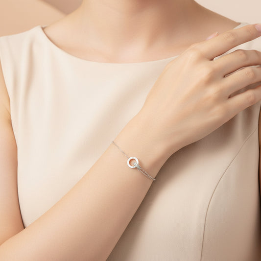 Elegant interlocking circles bracelet stainless steel worn on a hand with a neutral outfit