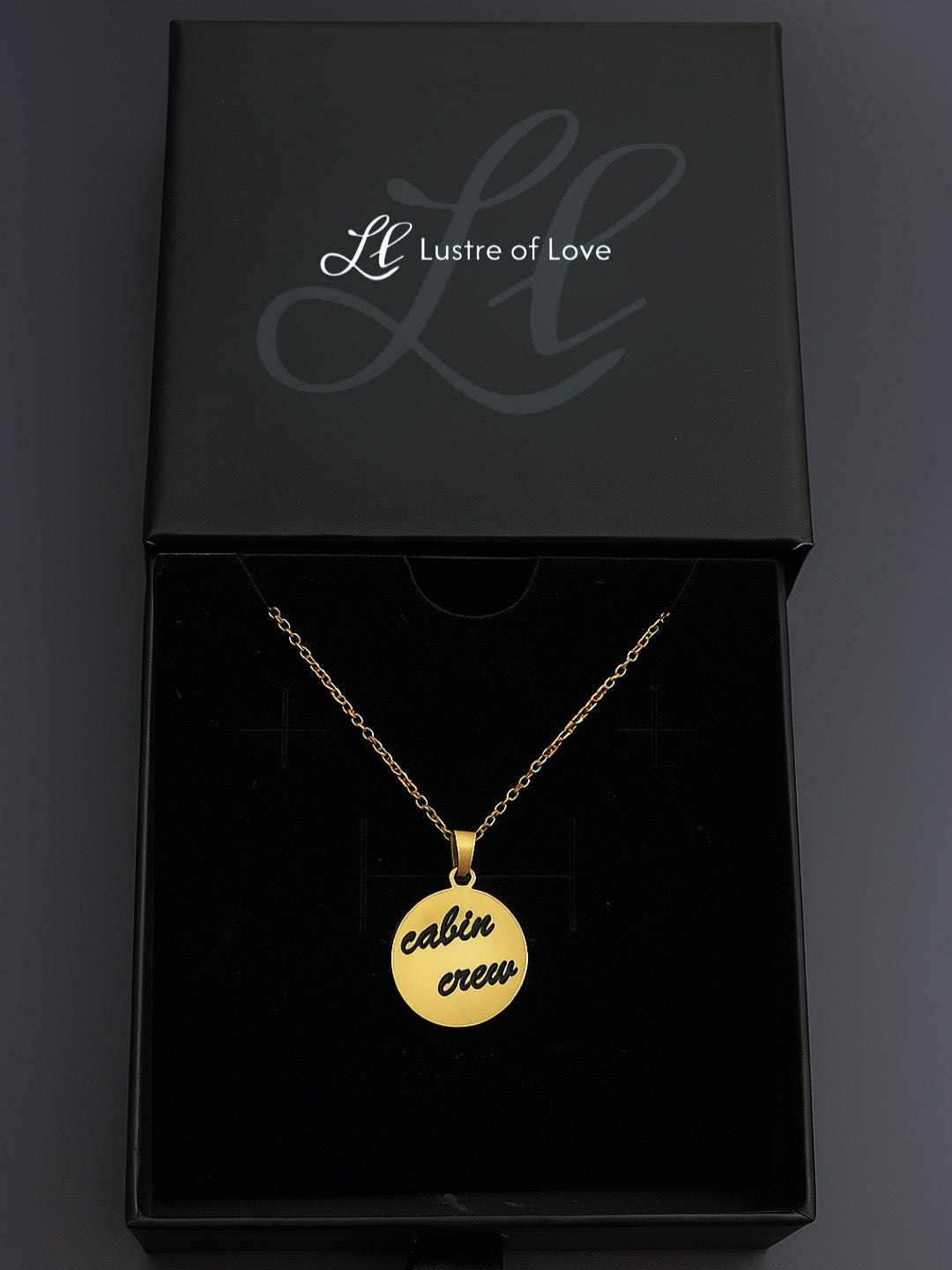 Gold custom round pendant engraved with cabin crew text in a Lustre of Love black gift box
