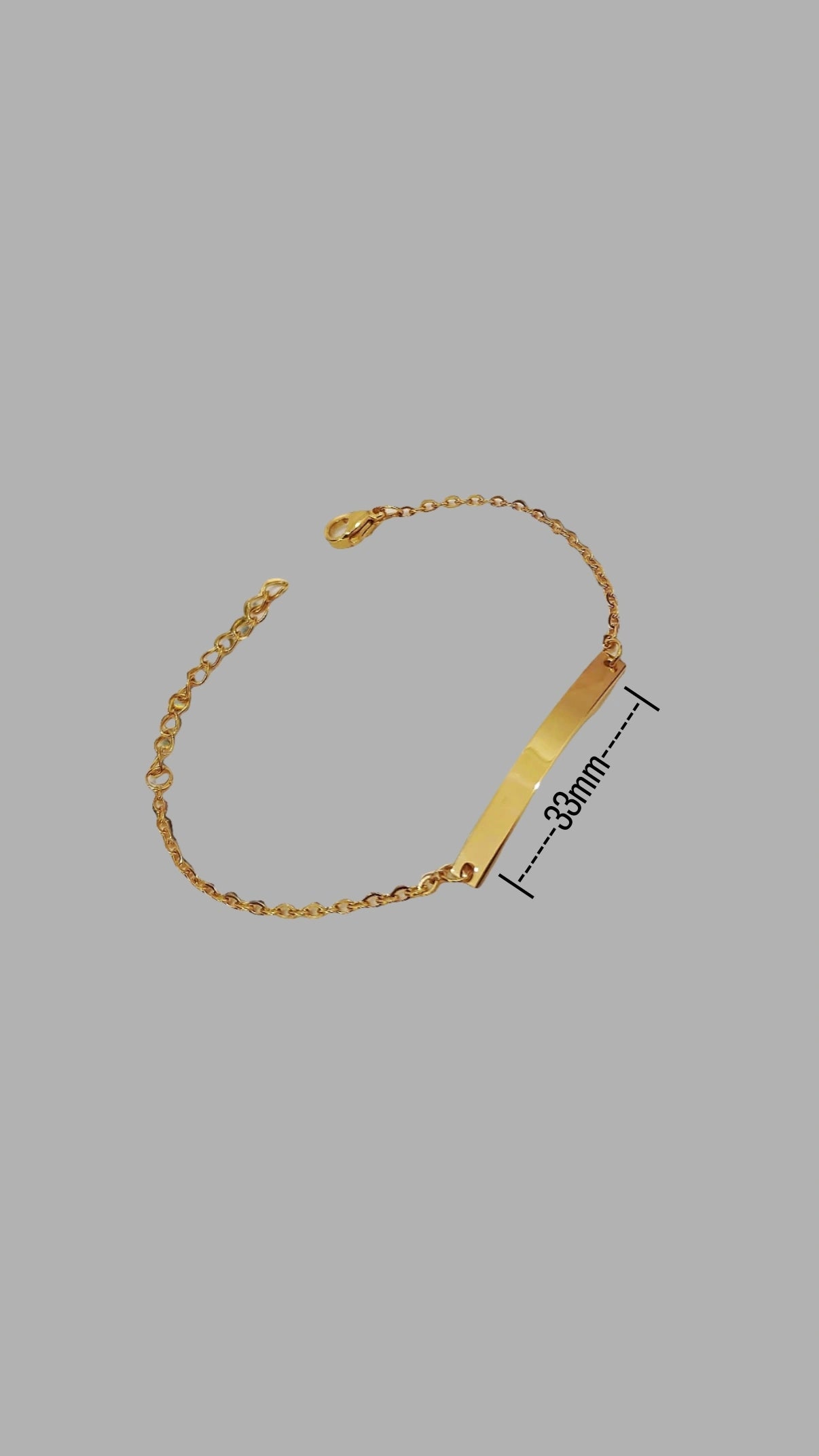 Lustre of Love gold bar bracelet with 33mm gold bar and adjustable chain on gray background