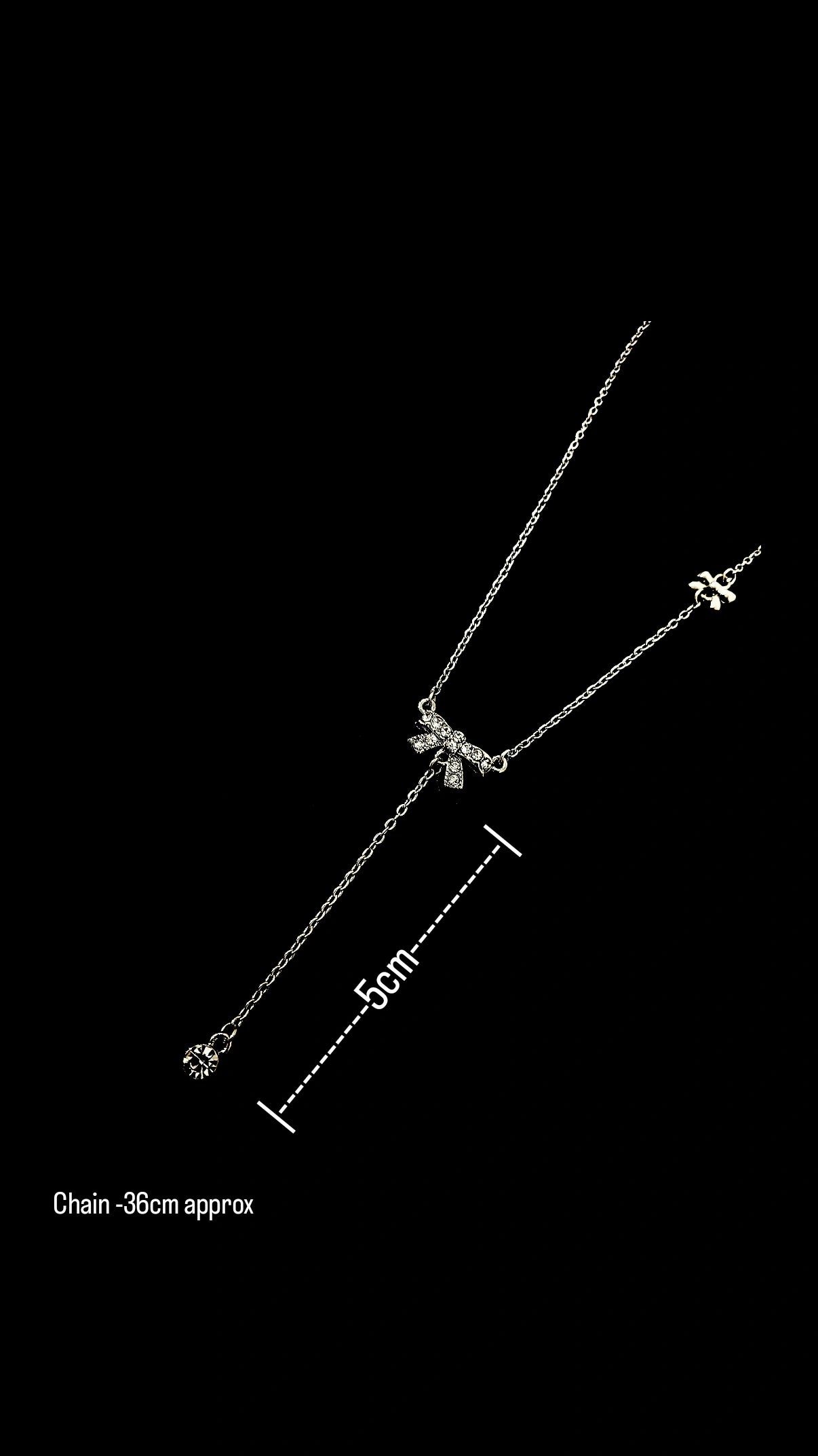 Silver bow charm necklace by Lustre of Love with delicate chain and adjustable length