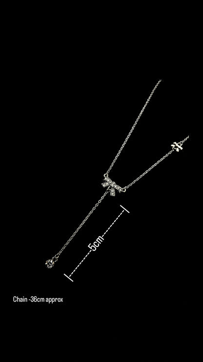 Silver bow charm necklace by Lustre of Love with delicate chain and adjustable length