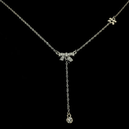 Lustre of Love delicate silver necklace featuring a sparkling bow charm with a dangling crystal pendant