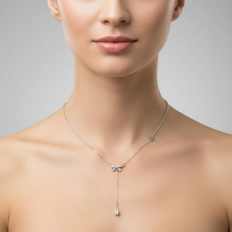 Lustre of Love delicate silver necklace featuring a sparkling bow charm with a dangling crystal pendant