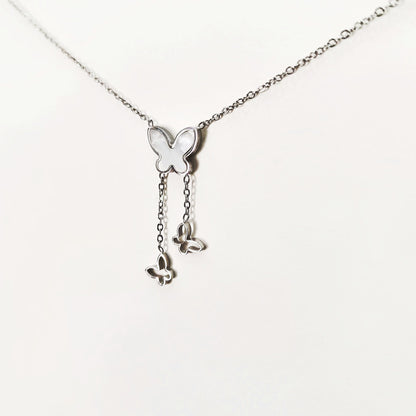 Silver butterfly pendant necklace with three butterfly charms hanging from delicate chain