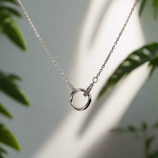 Lustre of Love silver interlocked ring pendant necklace with delicate chain in soft natural light
